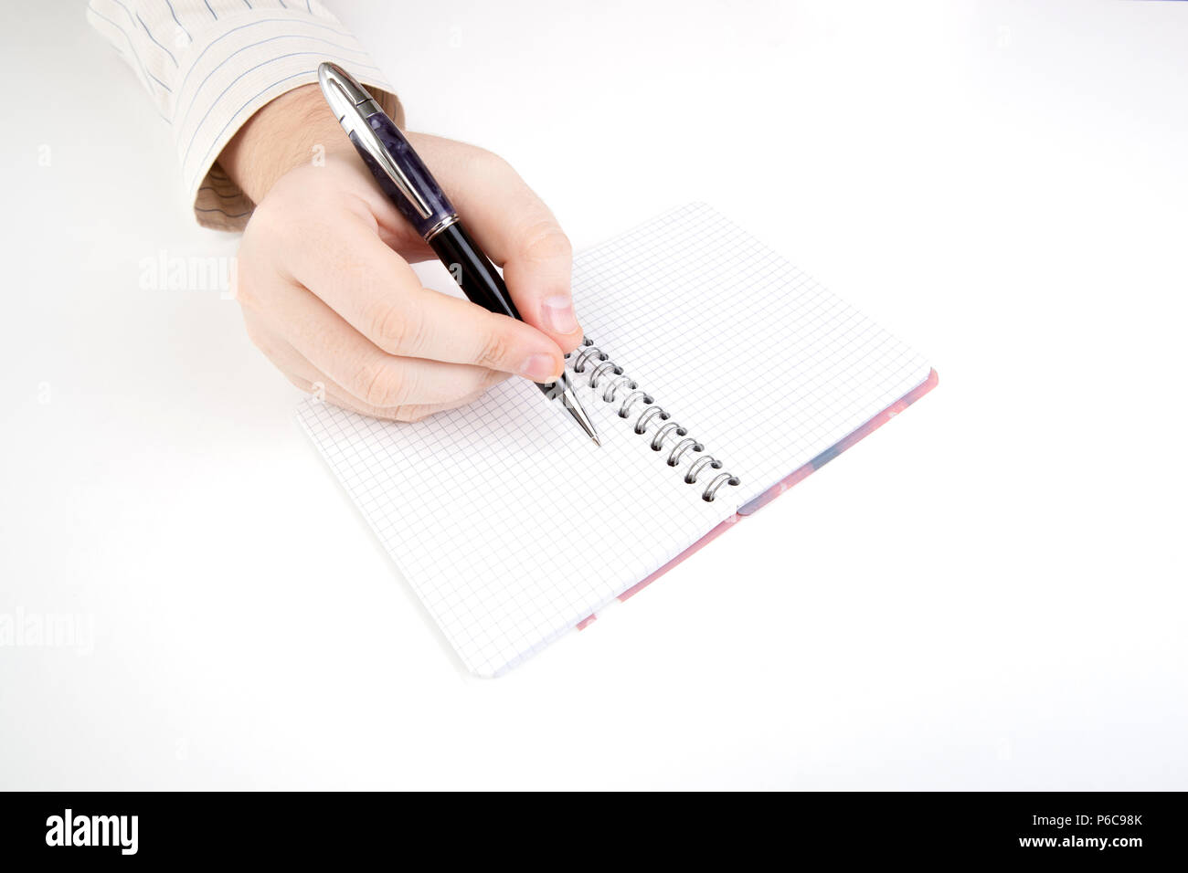 diary and human hand holding a pen close-up Stock Photo - Alamy