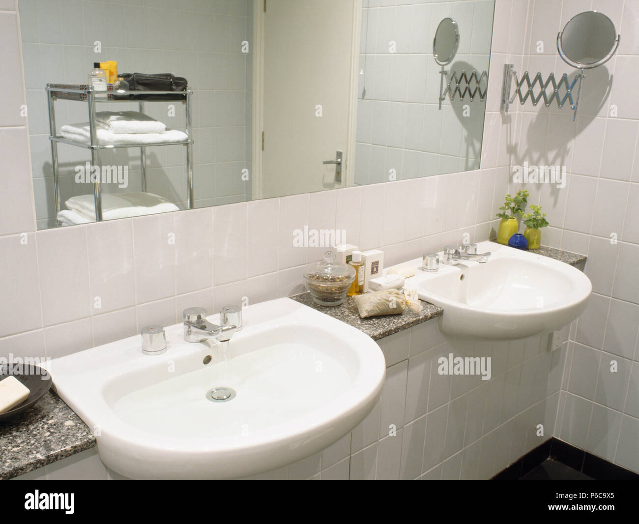 Double basins below mirror in modern white bathroom Stock Photo Alamy