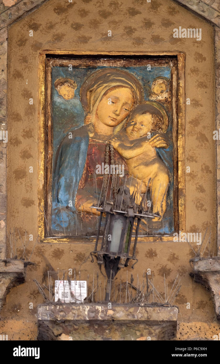 Virgin Mary with baby Jesus, house facade in Modena, Italy Stock Photo