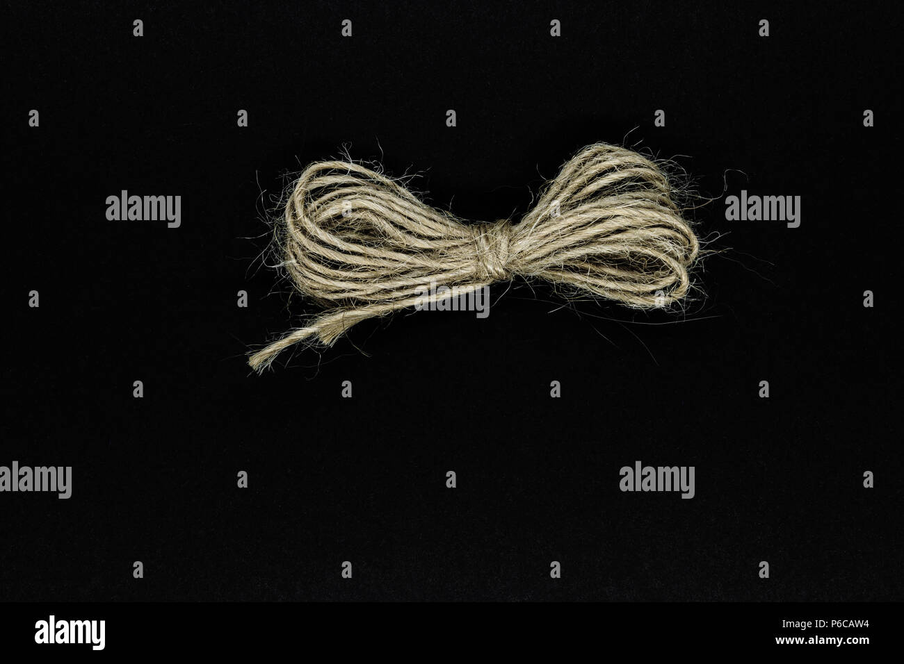 Ribbon from brown rope isolated on black background surface Stock Photo