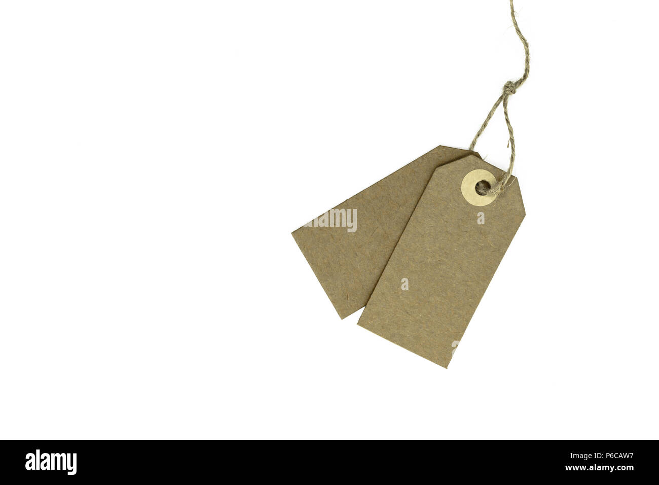 Two blank brown note cards with copy space stuffed on brown rope and isolated on white
