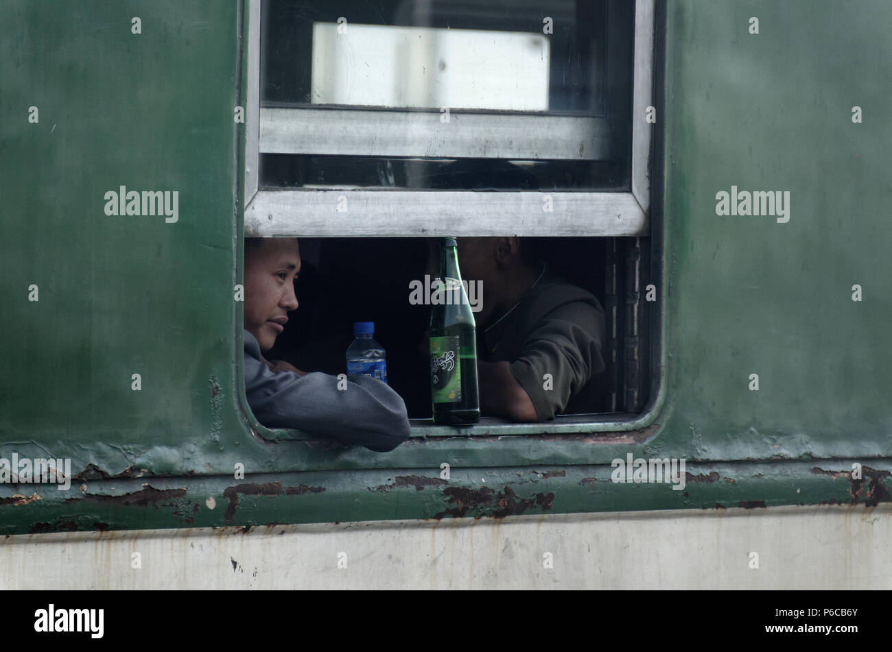Taedonggang No2 beer bottle propping open a window on a North Korean train close to Pyongyang Stock Photo