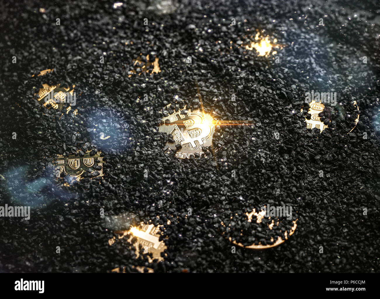 Mining Golden Bitcoins, coin bitcoin hidden on black coal background Stock  Photo - Alamy