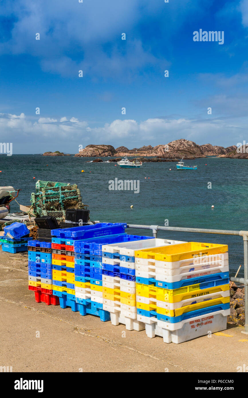 The pier at Fionnphort on the Isle of Mull is piled high with colourful fish boxes and lobster creels, Argyll and Bute, Scotland, UK Stock Photo