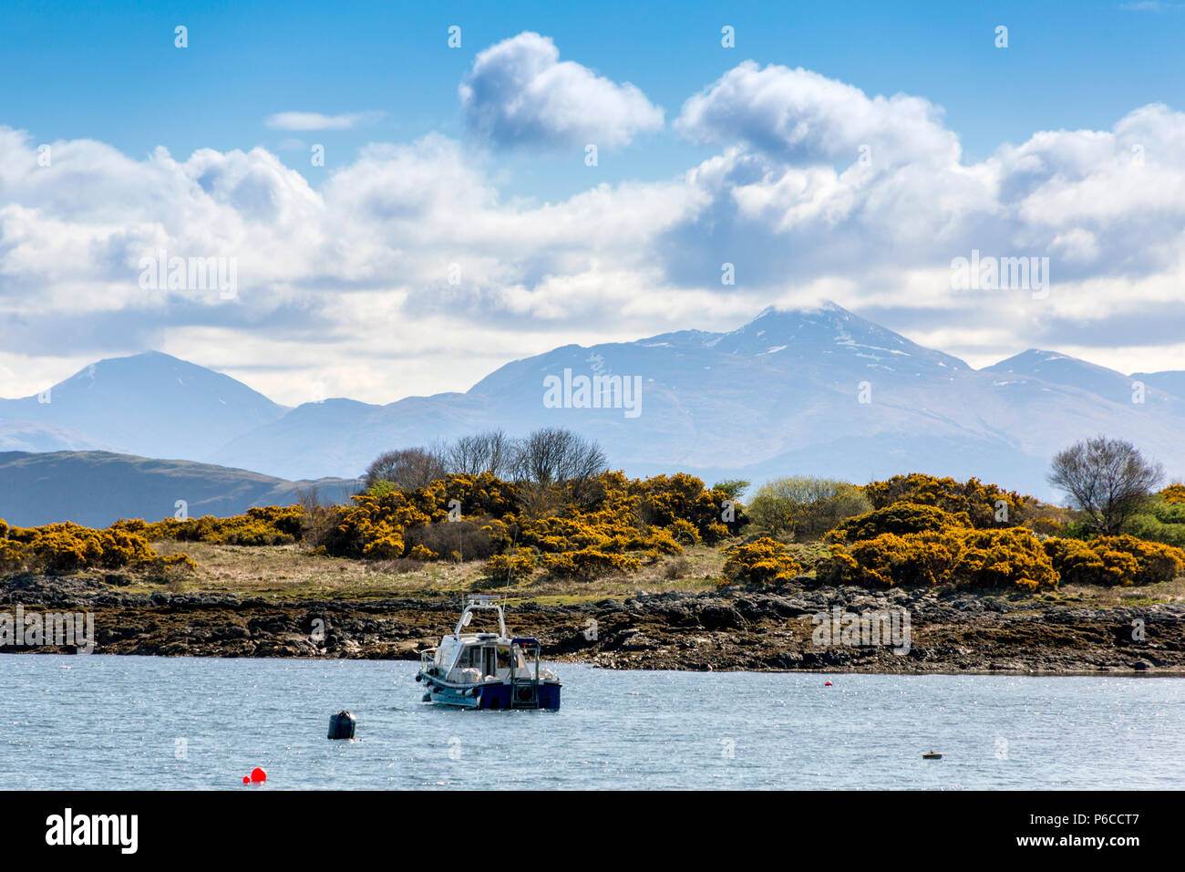 Looking across Lismore Island at snow on the summits of peaks beyond from an Oban - Mull ferry, Argyll and Bute, Scotland, UK Stock Photo