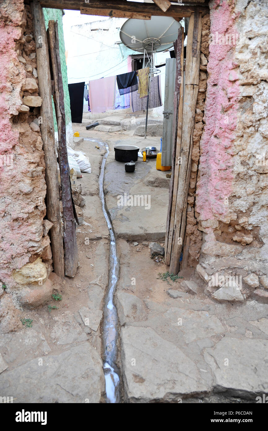 Ethiopia, Harar, view in the interior of a private courtyard where some waste water is coming out to the street Stock Photo