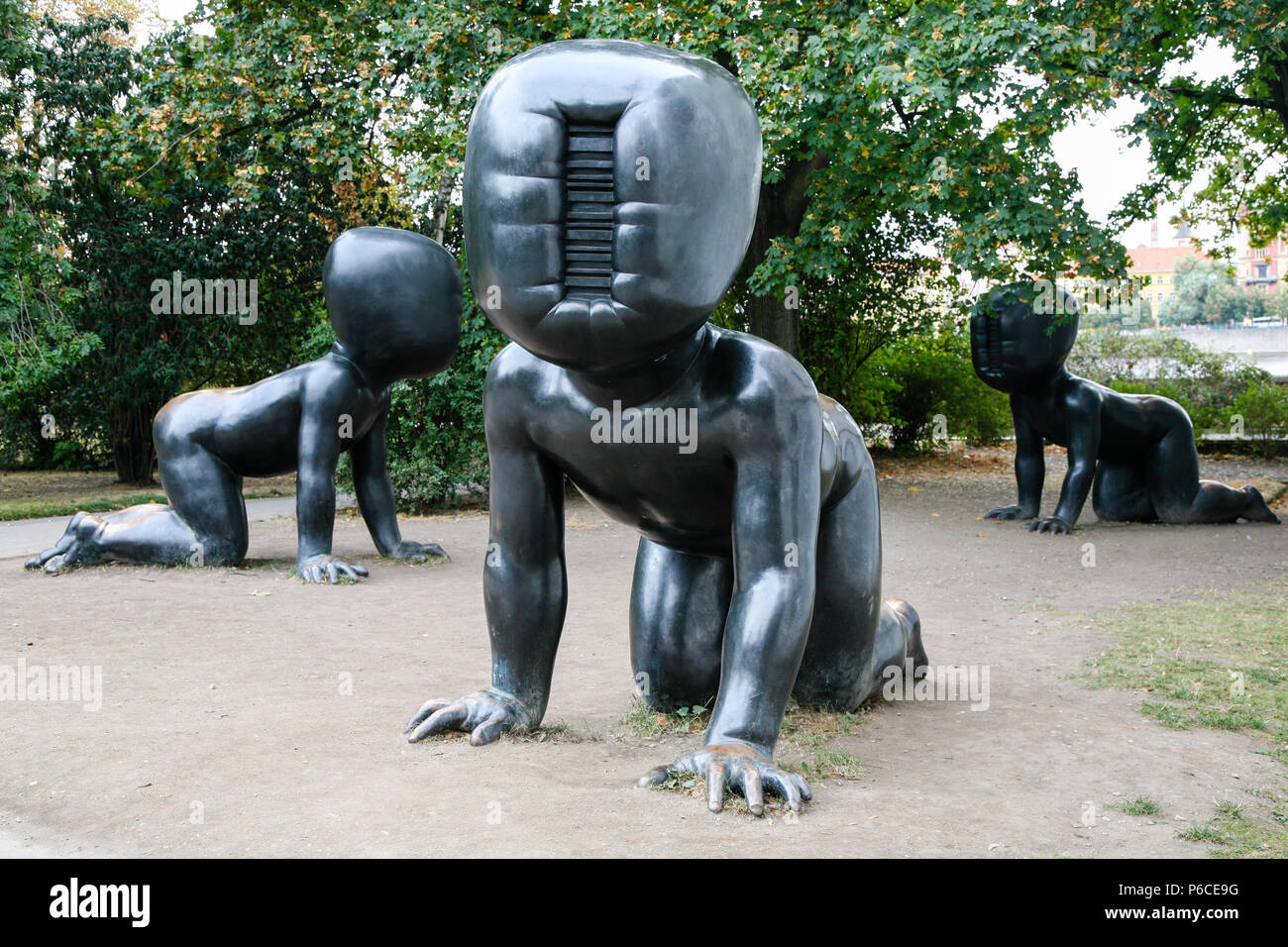 Three large crawling bronze babies sculptures in front of the Museum of Modern Art in Kampa Park, Prague, Czech Republic. Stock Photo