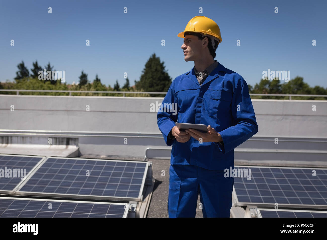 Male worker using digital tablet at solar station Stock Photo