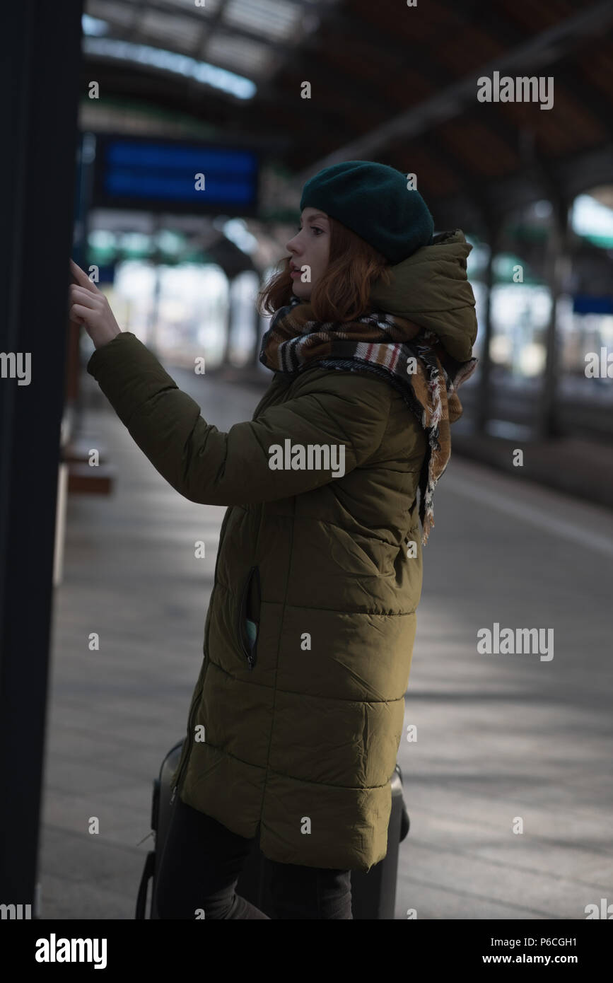 Woman checking the reservation list in platform Stock Photo