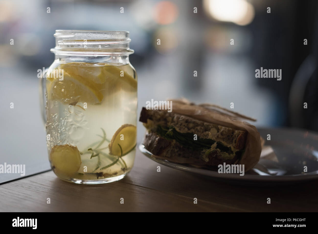 Jar of lemon tea with wrap food on plate Stock Photo