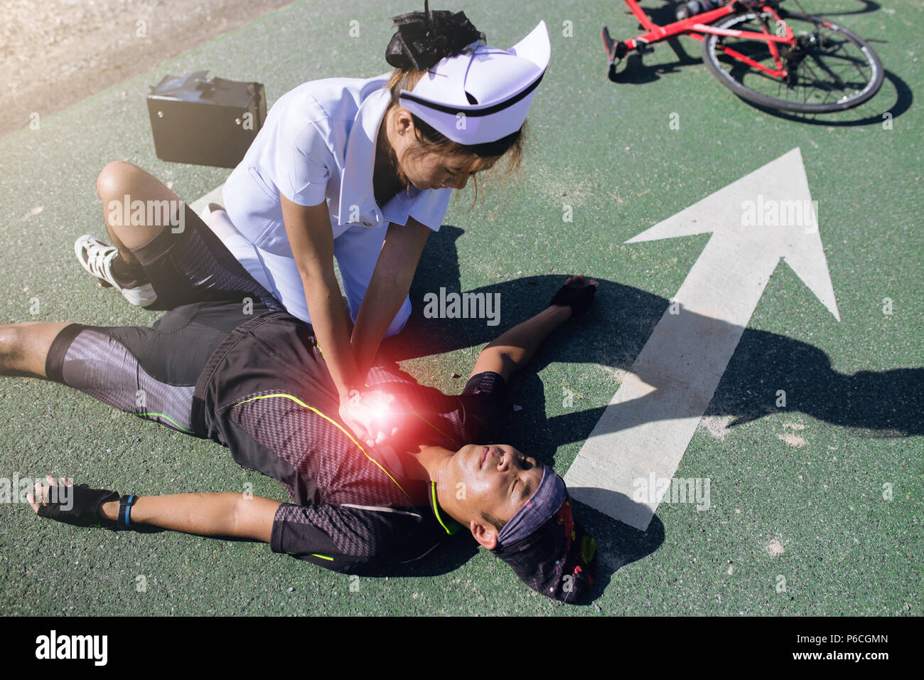 Female nurse helping Emergency CRP on bicycle man in an accident Stock ...