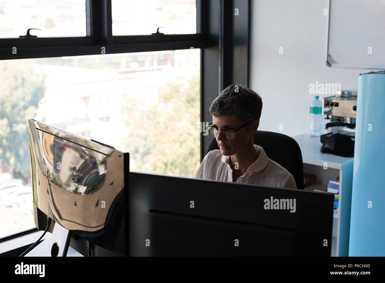 Mature businesswoman working on computer Stock Photo