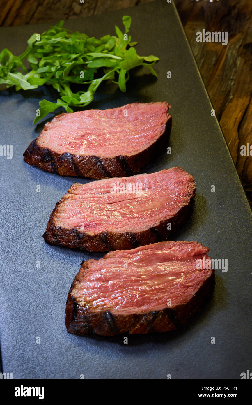 Sousvide steak cut into pieces, cooked to eat beef on the stone table