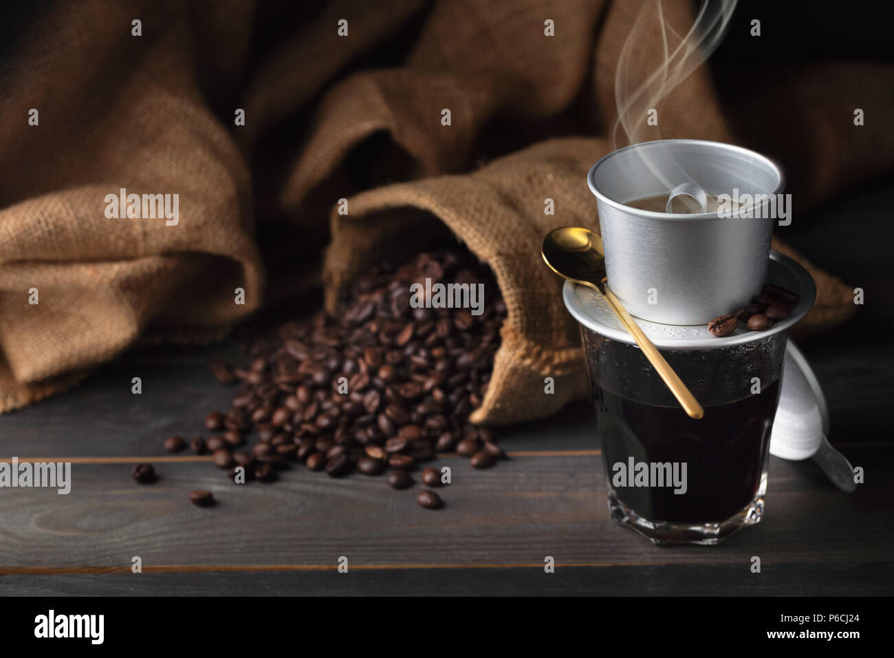 Vintage vietnam coffee dripper, coffee cup and coffee beans with bag