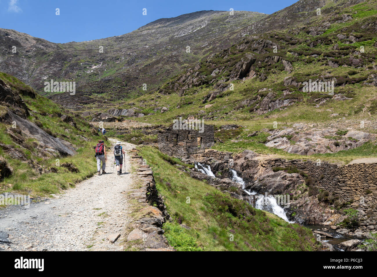 Two female hikers ascending the Watkin Path towards the summit of Snowdon, the highest mountain in the Snowdonia national Park in Wales. Stock Photo