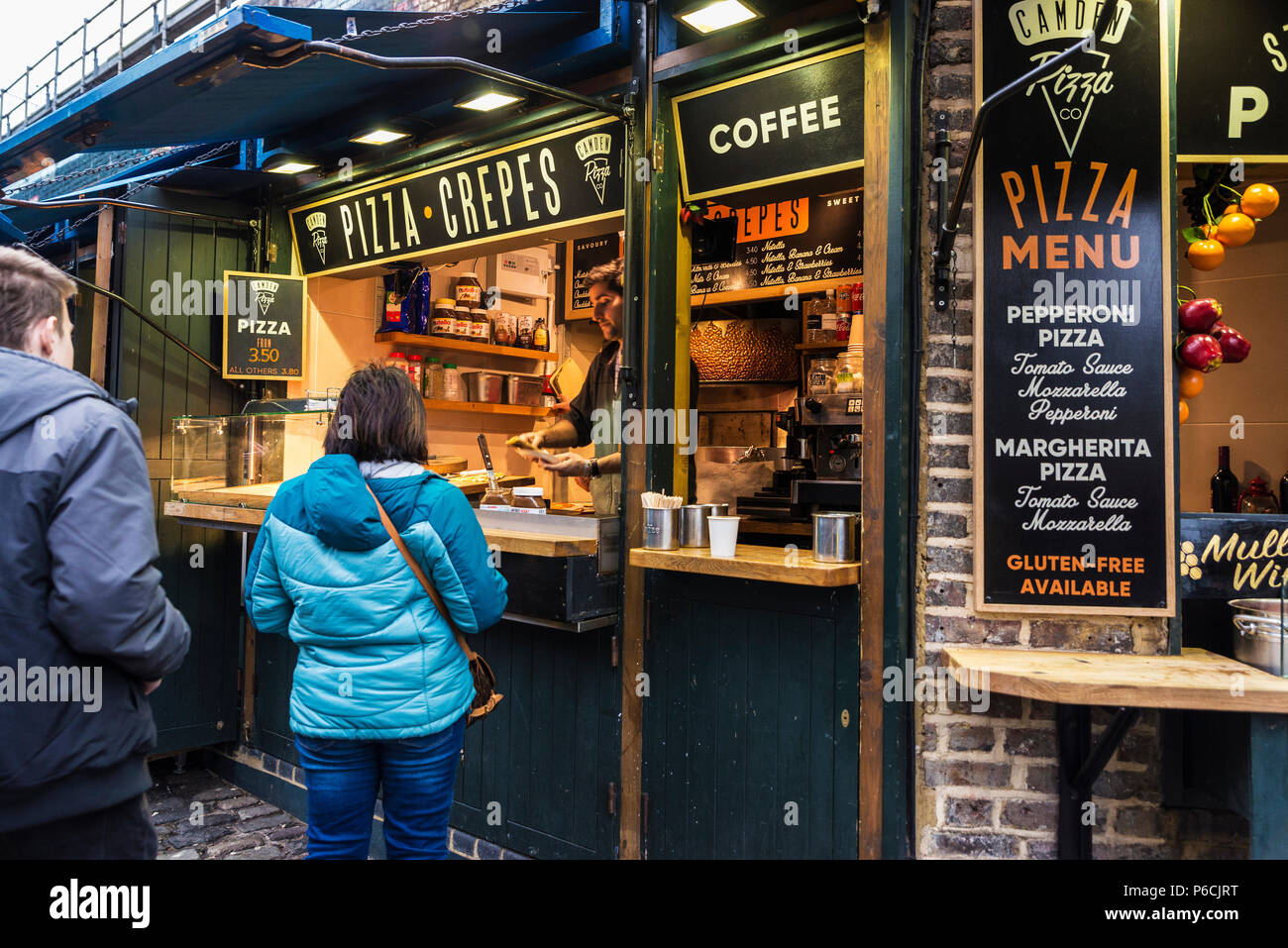 London, England UK  - December 31, 2017: Food stalls in Camden Lock Market or Camden Town with people around in London, England, United Kingdom Stock Photo