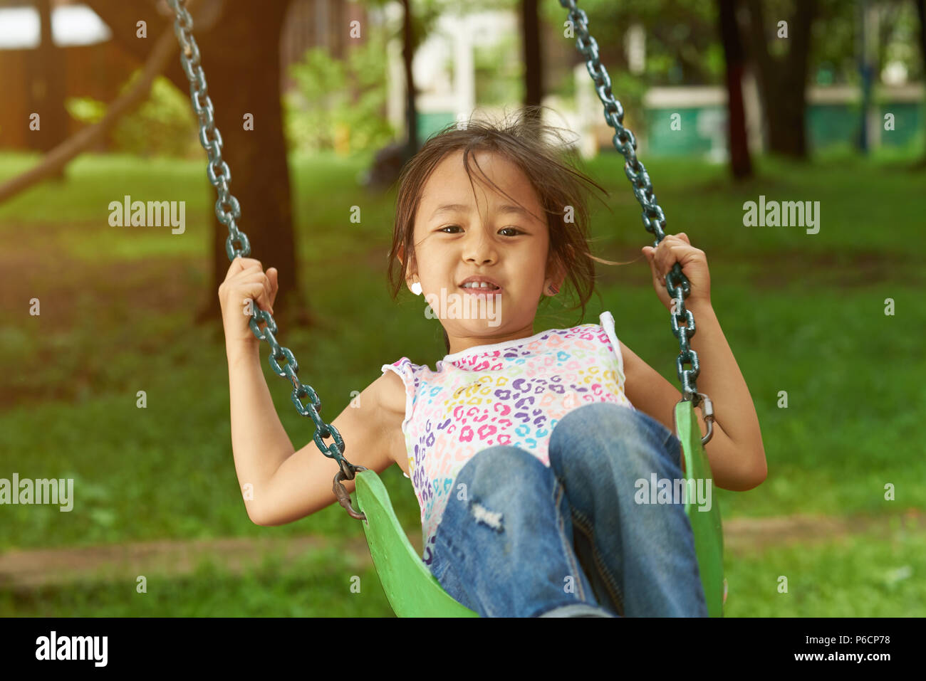 Asian girl playing on playground. Cute asian having fun in park Stock Photo