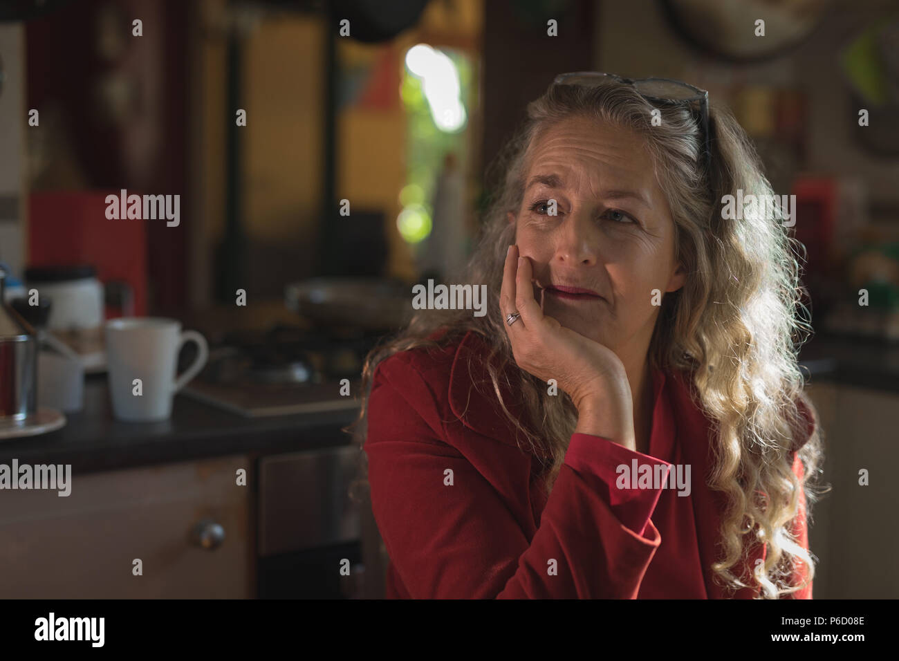 Mature woman thinking sitting hi-res stock photography and images - Alamy