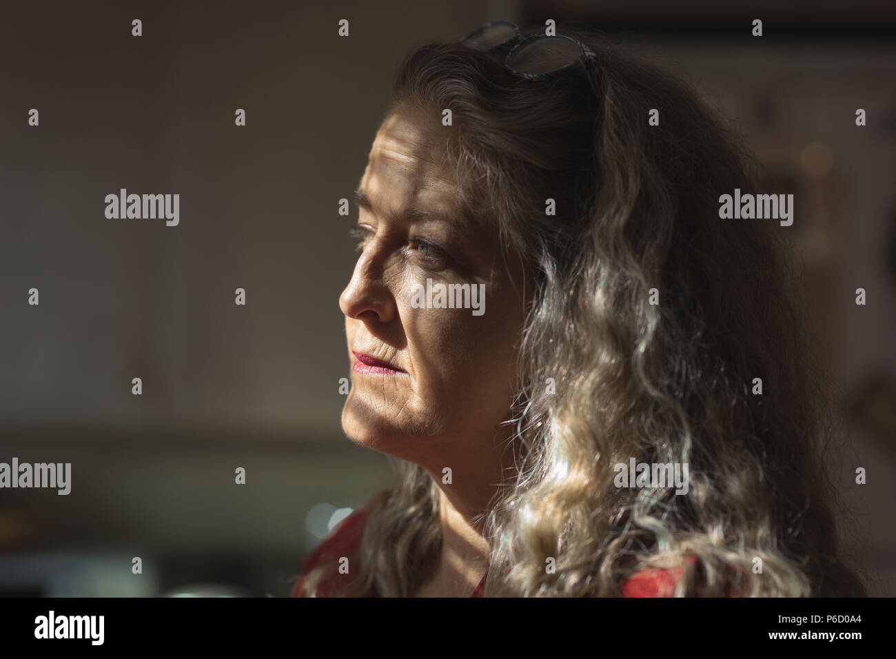 Mature woman thinking at home hi-res stock photography and images - Alamy