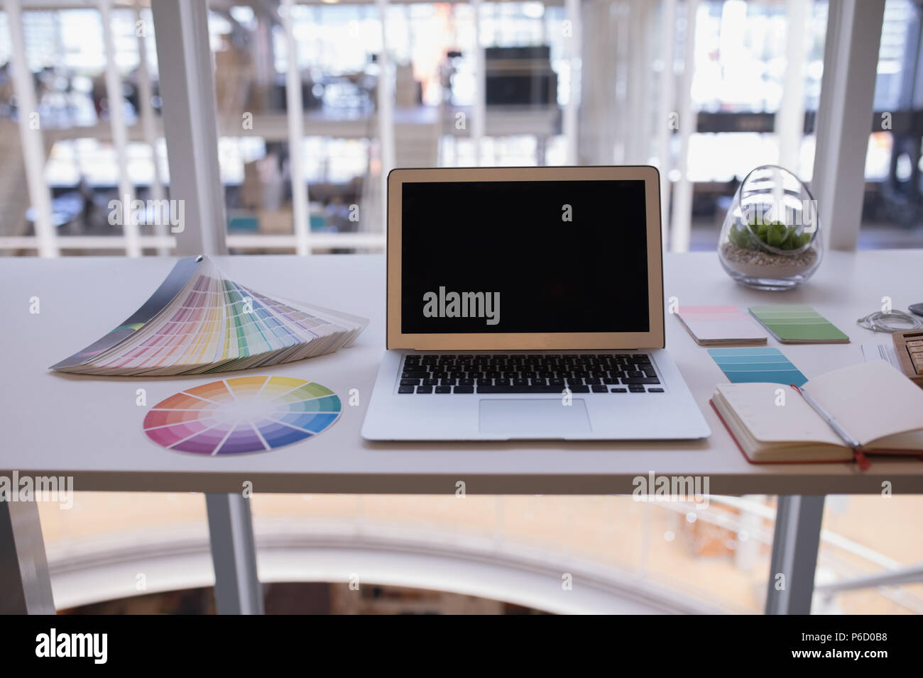 Laptop and color swatch at desk Stock Photo