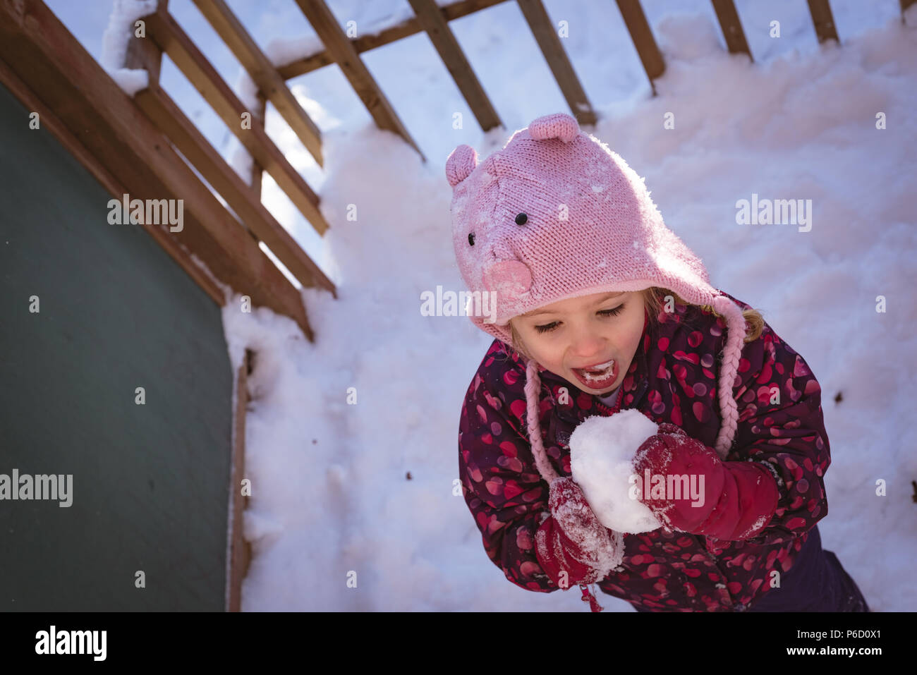 Cute girl licking snow during winter Stock Photo