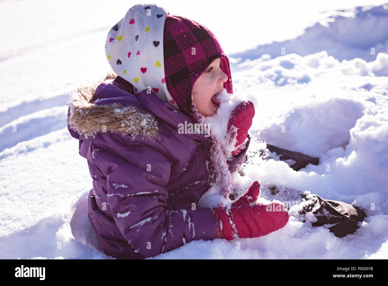 Cute girl licking snow Stock Photo