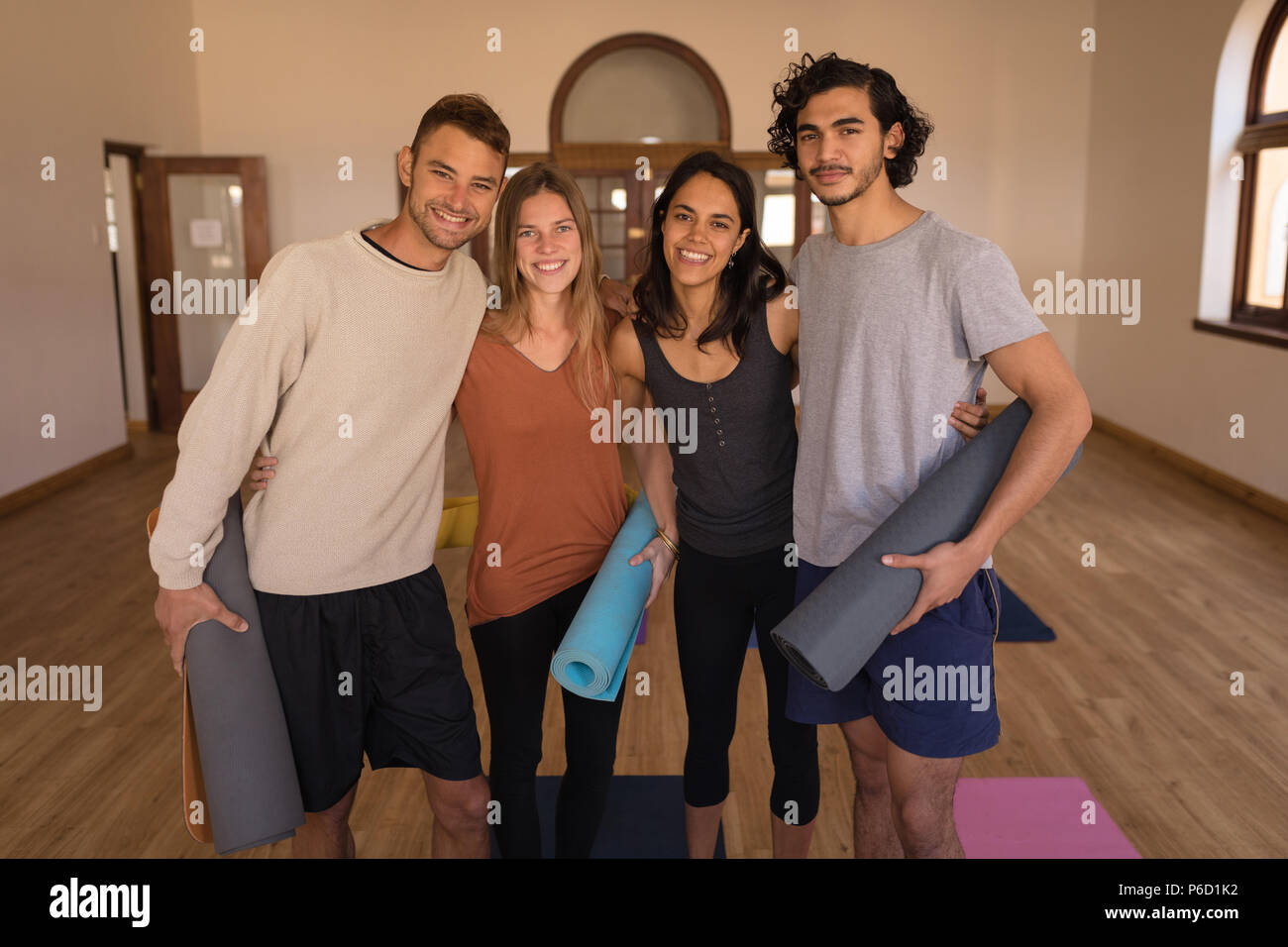 Group of friends standing with arm around Stock Photo