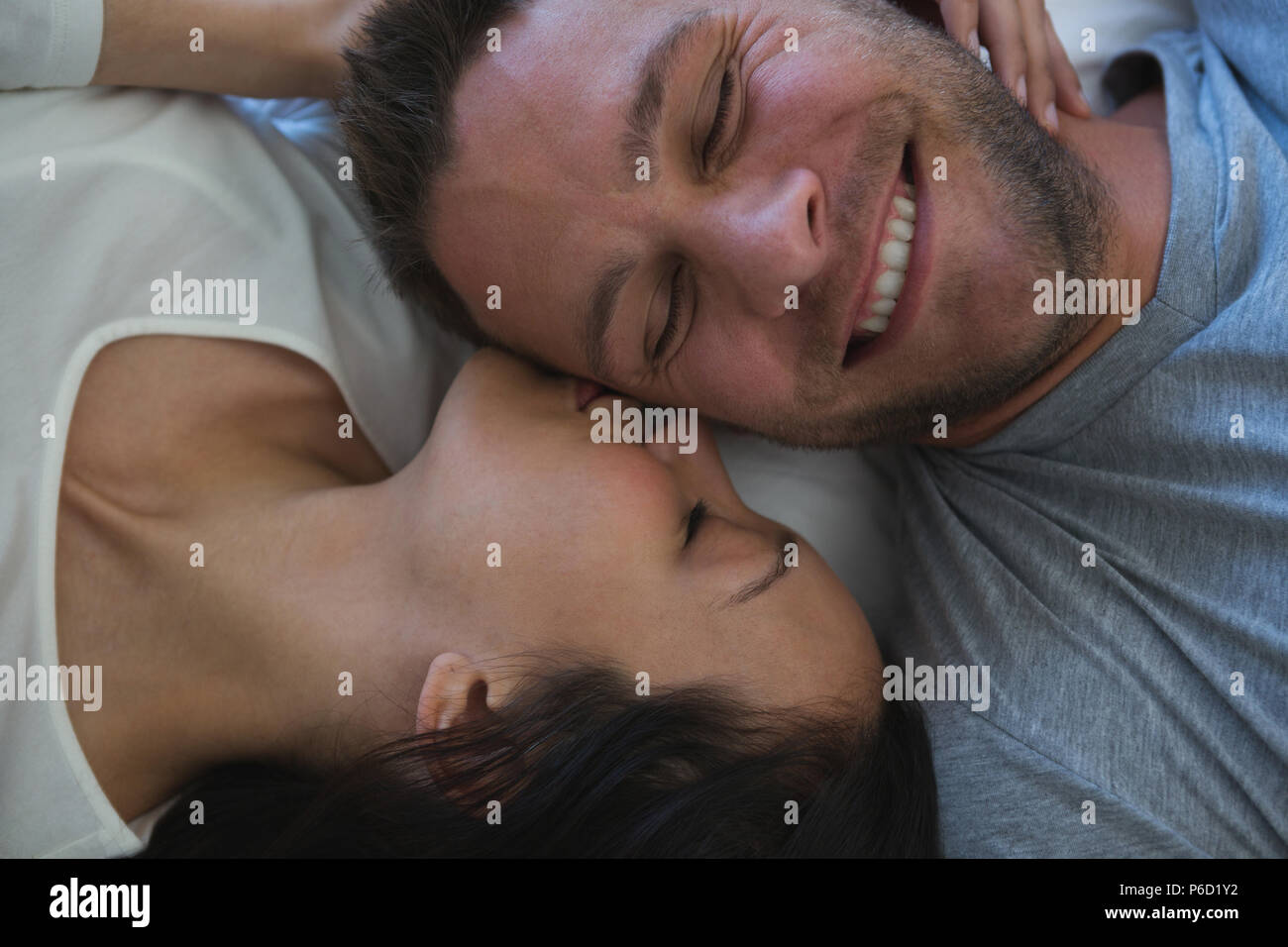 Romantic couple kissing in bed hi-res stock photography and images - Alamy