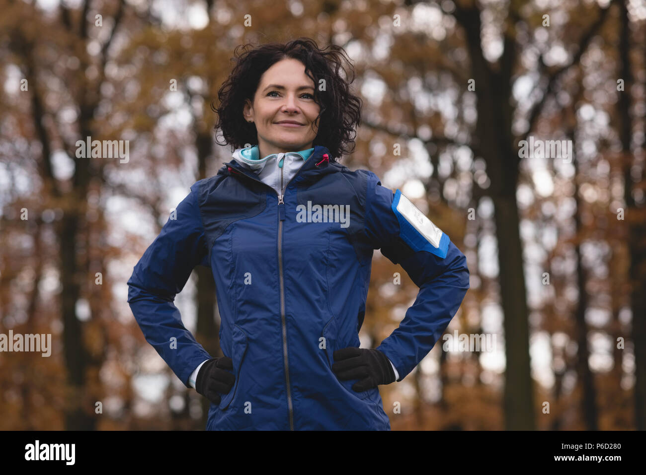 Woman standing with hands on hip in the park Stock Photo - Alamy
