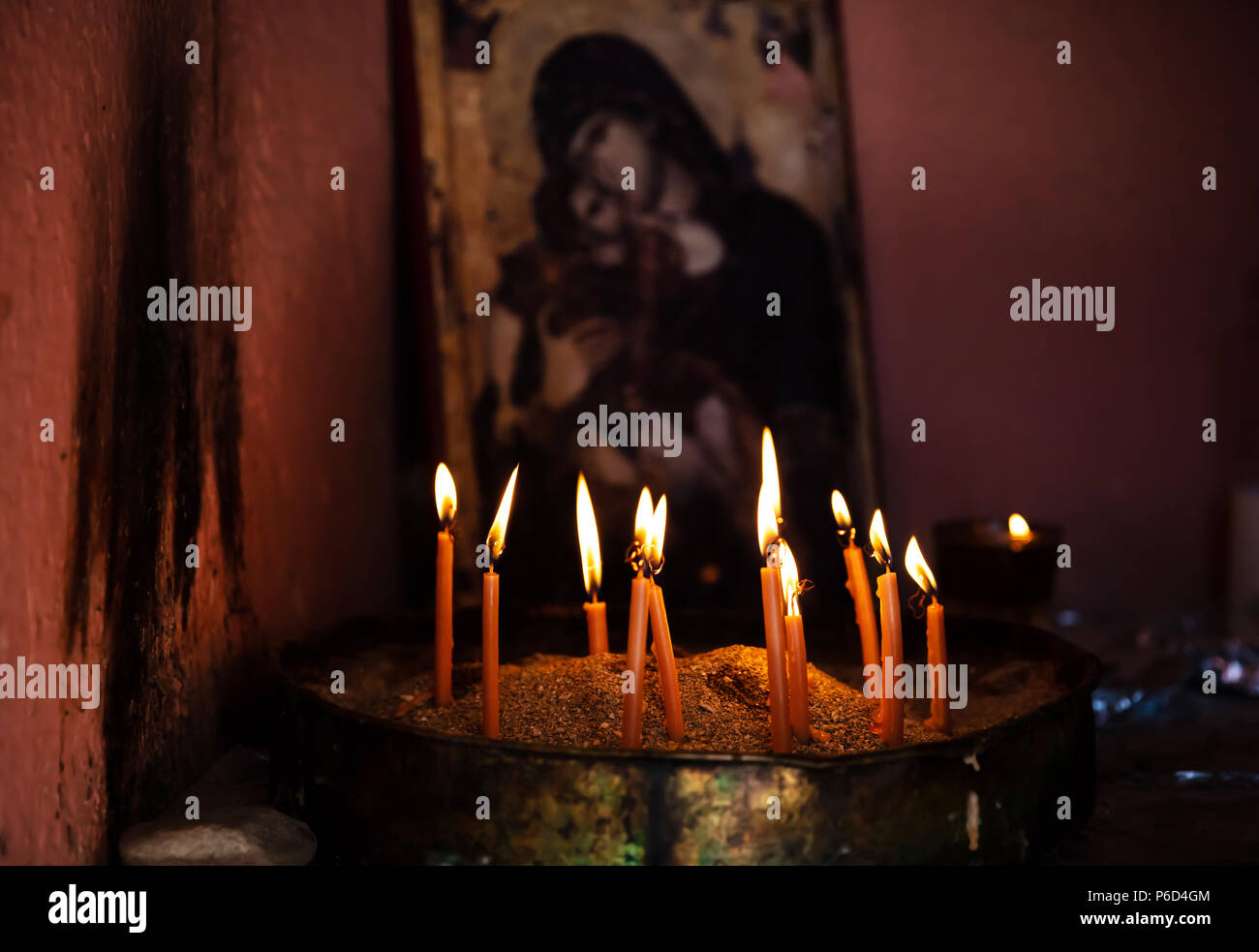 Sacred ritual concept. Prayer candles on a candlestick with sand