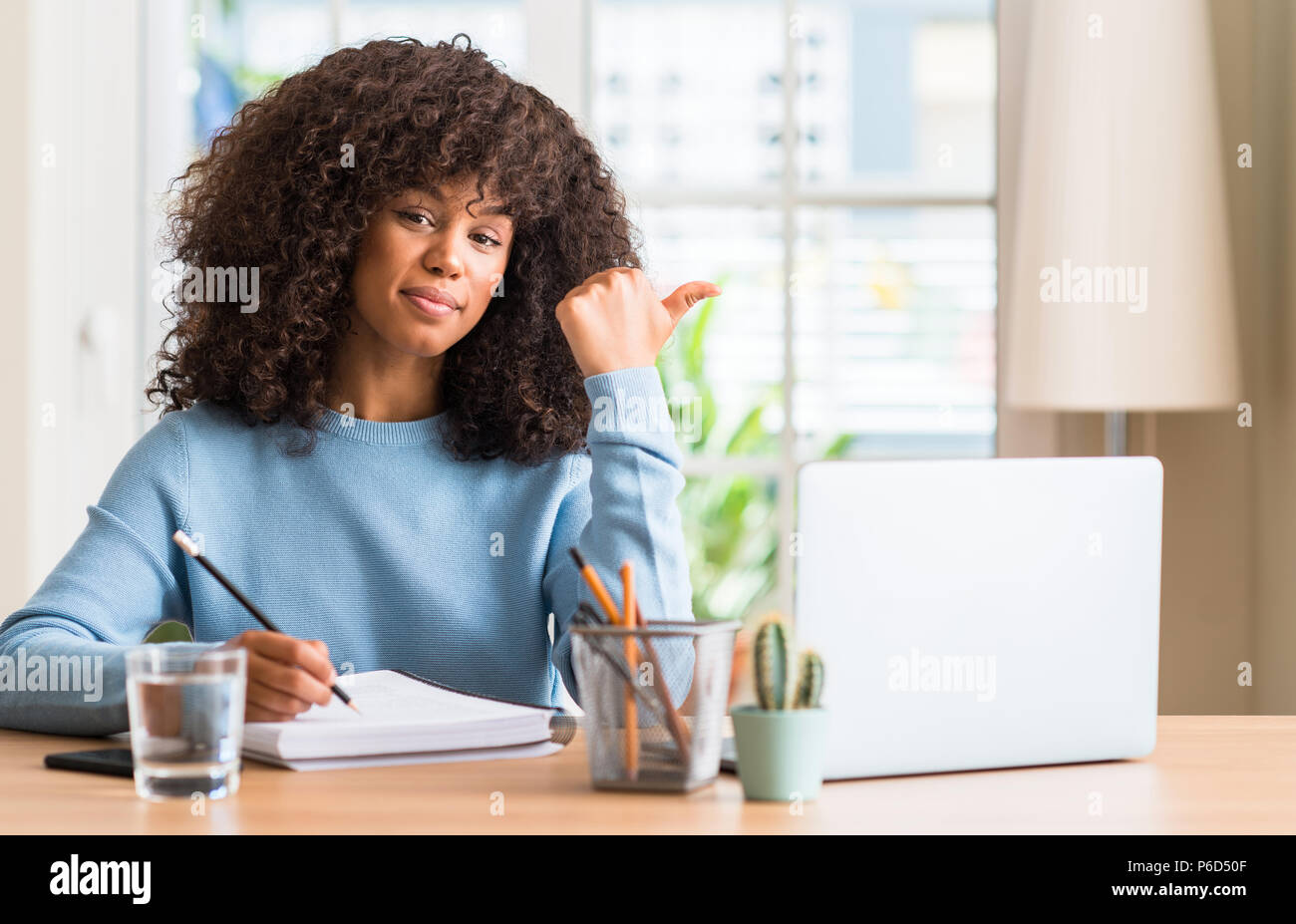African american woman studying at home using a computer laptop ...