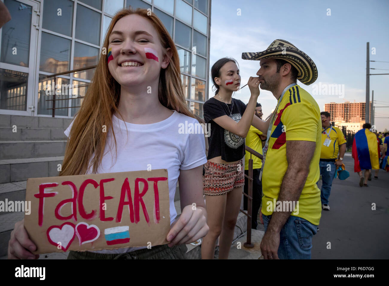 Young people draw flags of national teams on faces of football fans in Kazan city during the FIFA World Cup 2018 Russia Stock Photo
