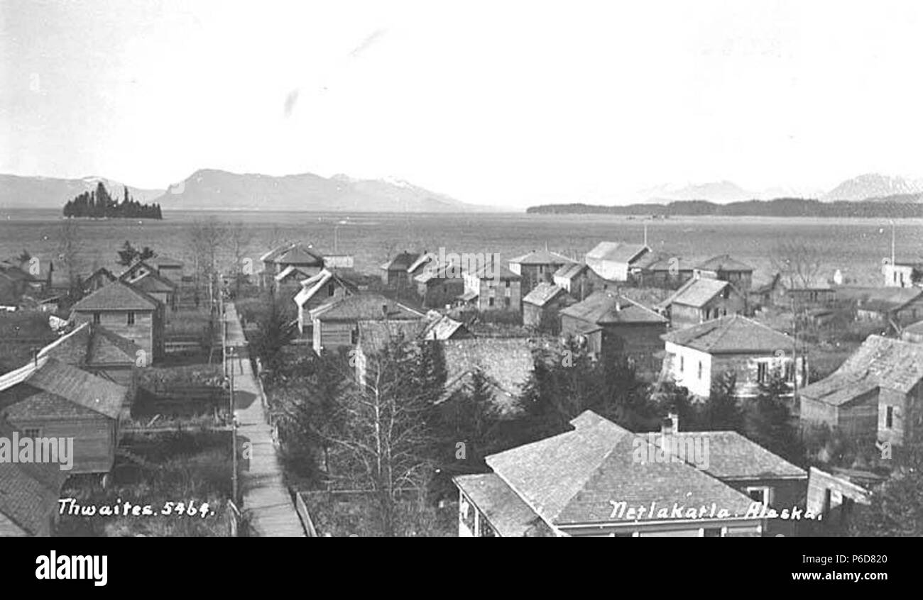 . English: View of Metlakatla, ca. 1912 . English: Most likely taken from the church bell tower. Cannery is visible on right side waterfront. Caption on image: Netlakatla, Alaska PH Coll 247.737 Metlakatla is located at Port Chester on the west coast of Annette Island, 15 miles south of Ketchikan. Metlakatla means 'saltwater channel passage' and was founded by a group of Canadian Tsimshians who migrated from Prince Rupert, British Columbia in 1887 seeking religious freedom. They were led by a Scottish lay priest in the Anglican Church (Church of England), Reverend William Duncan, who had begun Stock Photo
