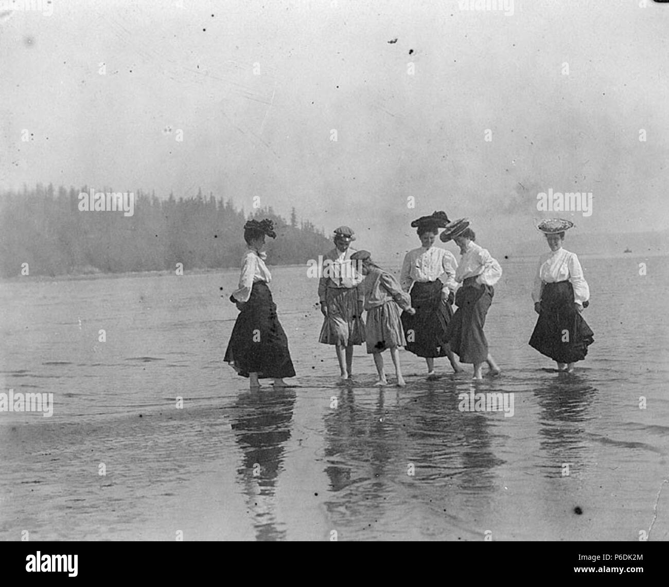. English: Laura, Miriam and friends cooling their feet at South Beach below Fort Lawton, Washington, 1905 . English: Text from Kiehl log: Picnickers at Fort Lawton, 1905 Album 1.61 Subjects (LCSH): Kiehl, Laura; Kiehl, Miriam; Young women--Washington (State)--Seattle; Beaches--Washington (State)--Seattle; Magnolia (Seattle, Wash.) Concepts: Recreational activities  . 1905 60 Laura, Miriam and friends cooling their feet at South Beach below Fort Lawton, Washington, 1905 (KIEHL 274) Stock Photo