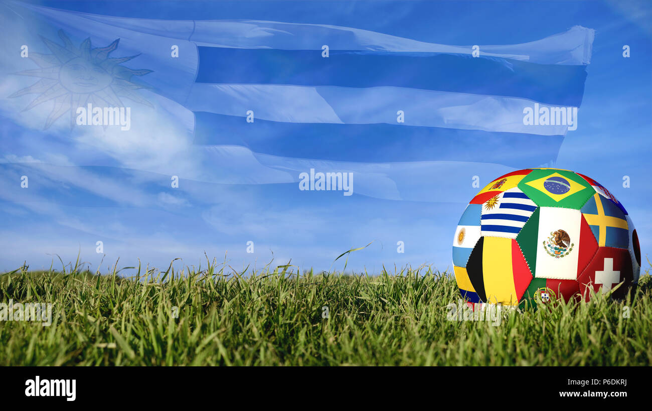 Soccer ball with Uruguay flag for russian sport event, Uruguayan team celebration. Realistic football on grass field over blue sky background. Include Stock Photo