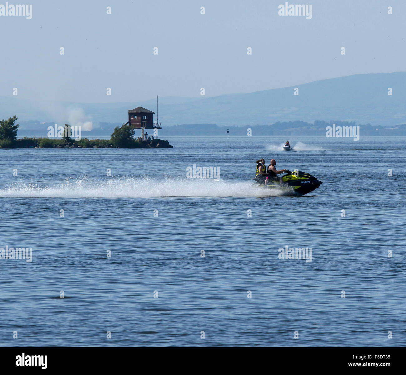 Lough Neagh, Northern Ireland. 29 June 2018. UK weather - another glorious summer day as the heatwave continues. Lough Neagh is the UK's largest freshwater lake and with weather like this it's a great place to enjoy the best summer in decades. Jetskiers on Lough Neagh. Credit: David Hunter/Alamy Live News. Stock Photo