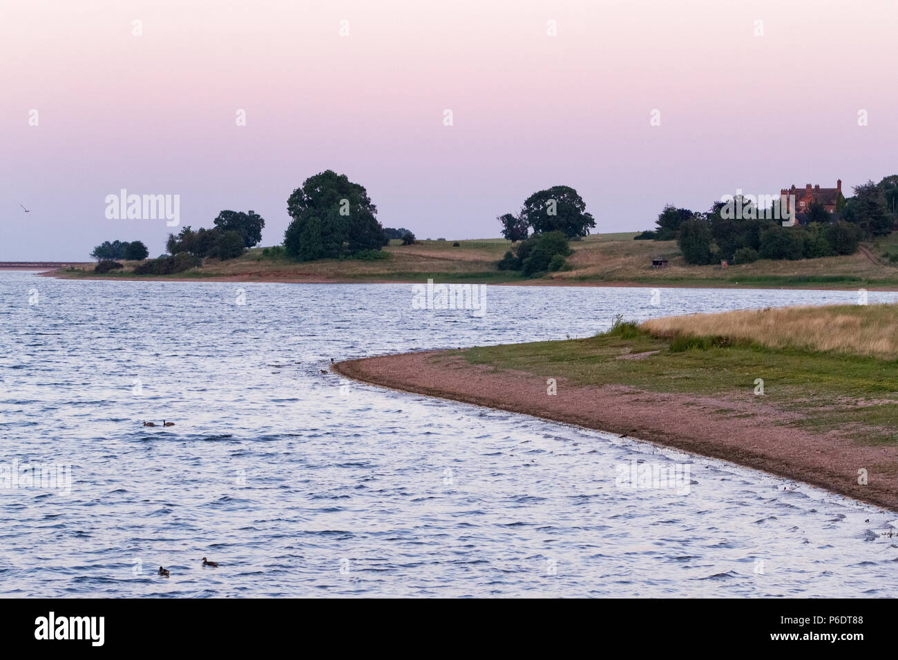 Blithfield Reservoir, Staffordshire, UK. 29th June 2018. The water level at Blithfield Reservoir, near Rugeley, Staffordshire, is very low after another hot day during the current UK heatwave, seen during sunset. Due to lack of supply, some regions have begun to impose hosepipe bans. 29th June 2018. Credit: Richard Holmes/Alamy Live News Stock Photo