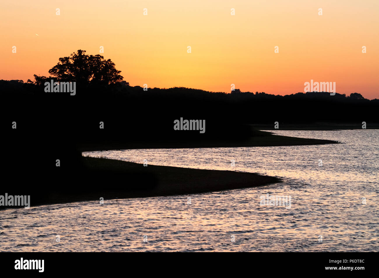 Blithfield Reservoir, Staffordshire, UK. 29th June 2018. The water level at Blithfield Reservoir, near Rugeley, Staffordshire, is very low after another hot day during the current UK heatwave, seen during sunset. Due to lack of supply, some regions have begun to impose hosepipe bans. 29th June 2018. Credit: Richard Holmes/Alamy Live News Stock Photo