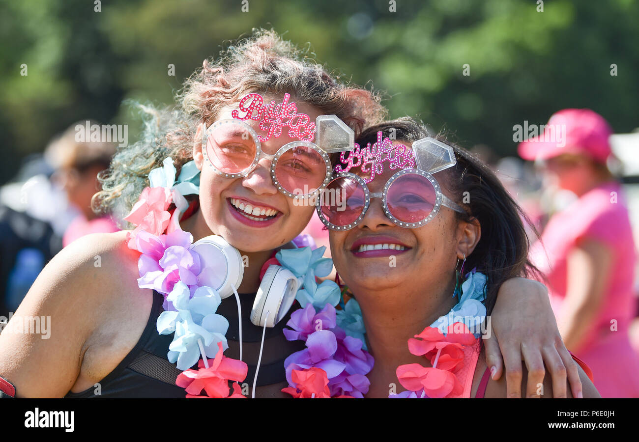 Brighton UK 30th June 2018 - Zara Breden (left) and her moth Sarah take  part in the Cancer Research UK Race For Life event held in Stanmer Park  Brighton . Thousands take