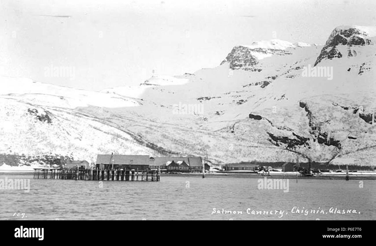 . English: Salmon cannery, Chignik, ca. 1912 . English: Caption on image: Salmon cannery, Chignik, Alaska PH Coll 247.30 The City of Chignik is located on Anchorage Bay on south shore of the Alaska Peninsula, 450 miles southwest of Anchorage and 260 miles southwest of Kodiak. Prior to Chignik, a Kaniagmuit Native village called Kaluak was located here; it was destroyed during the Russian fur boom in the late 1700s. Chignik, a Sugpiaq word meaning 'big wind' was established in the late 1800s as a fishing village and cannery. A four-masted sailing ship called the 'Star of Alaska' transported wor Stock Photo