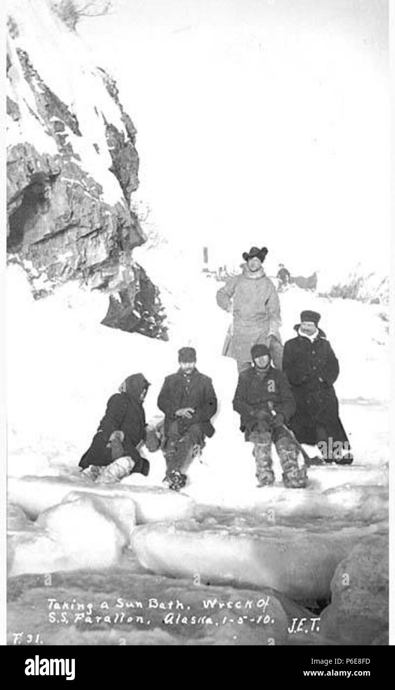 . English: Survivors from the FARALLON enjoying sunshine, Iliamna Bay, January 1910 . English: The Alaska Steamship Co.'s steam schooner Farallon which serviced southeastern Alaska was wrecked in Iliamna Bay on January 5, 1910. John Thwaites was among the shipwrecked passengers. Caption on image: Taking a sun bath. Wreck of S.S. Farallon. Alaska, 1-5-10 . PH Coll 247.113 Subjects (LCTGM): Fallon (Ship); Men--Alaska; Alaska Steamship Co.--People--Alaska Subjects (LCSH): Shipwreck victims--Alaska--Iliamna Bay; Survival after airplane accidents, shipwrecks, etc.--Alaska--Iliamna Bay  . 1910 75 Su Stock Photo