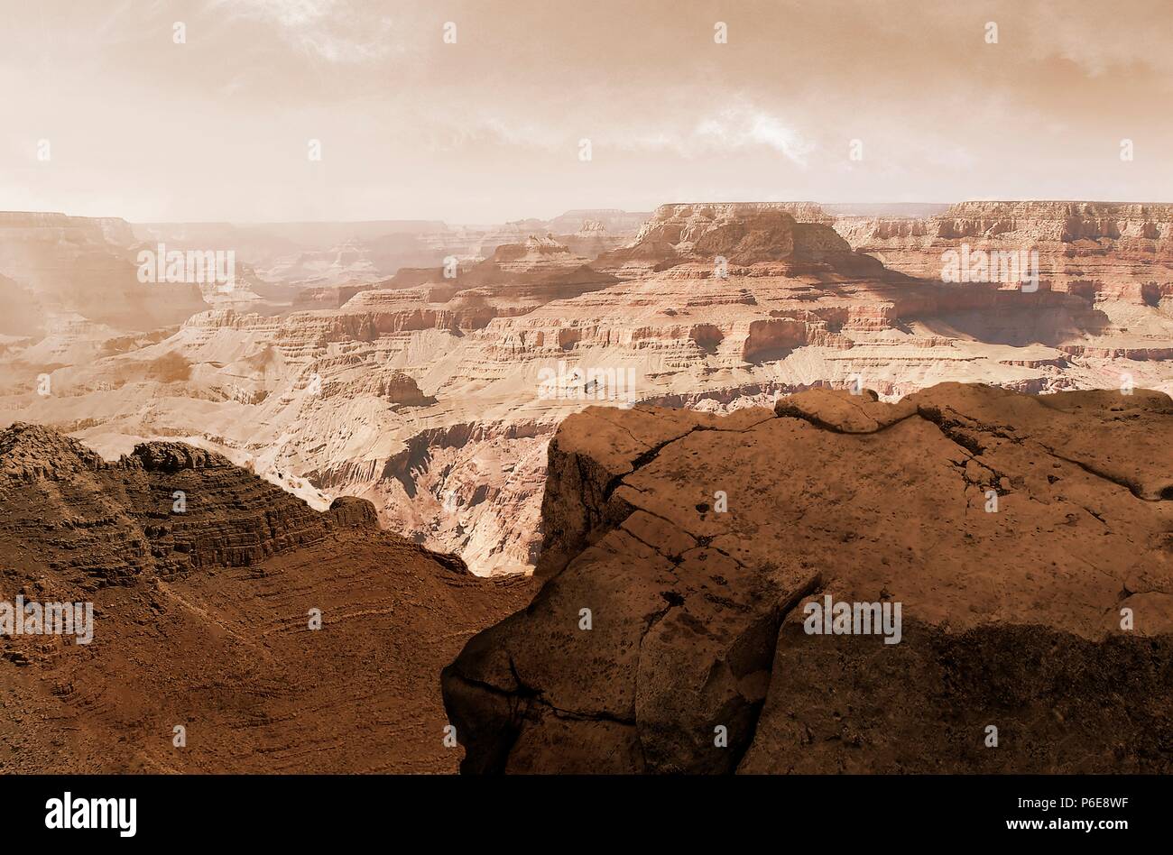 Illustration of the Valles Marineris canyon system on Mars as the Sun sets. The Valles Marineris is over 4000 kilometres (km) long, up to 200 km wide and up to 7 km deep, dwarfing the Grand Canyon of Arizona, USA. The canyons are found on the southeastern edge of the Tharsis Bulge and were originally created by faulting during the formation of Tharsis. The canyons have been further worn down by water and wind erosion. Finally, slumping has helped widen the canyon so that the bottom is visible from space. Stock Photo