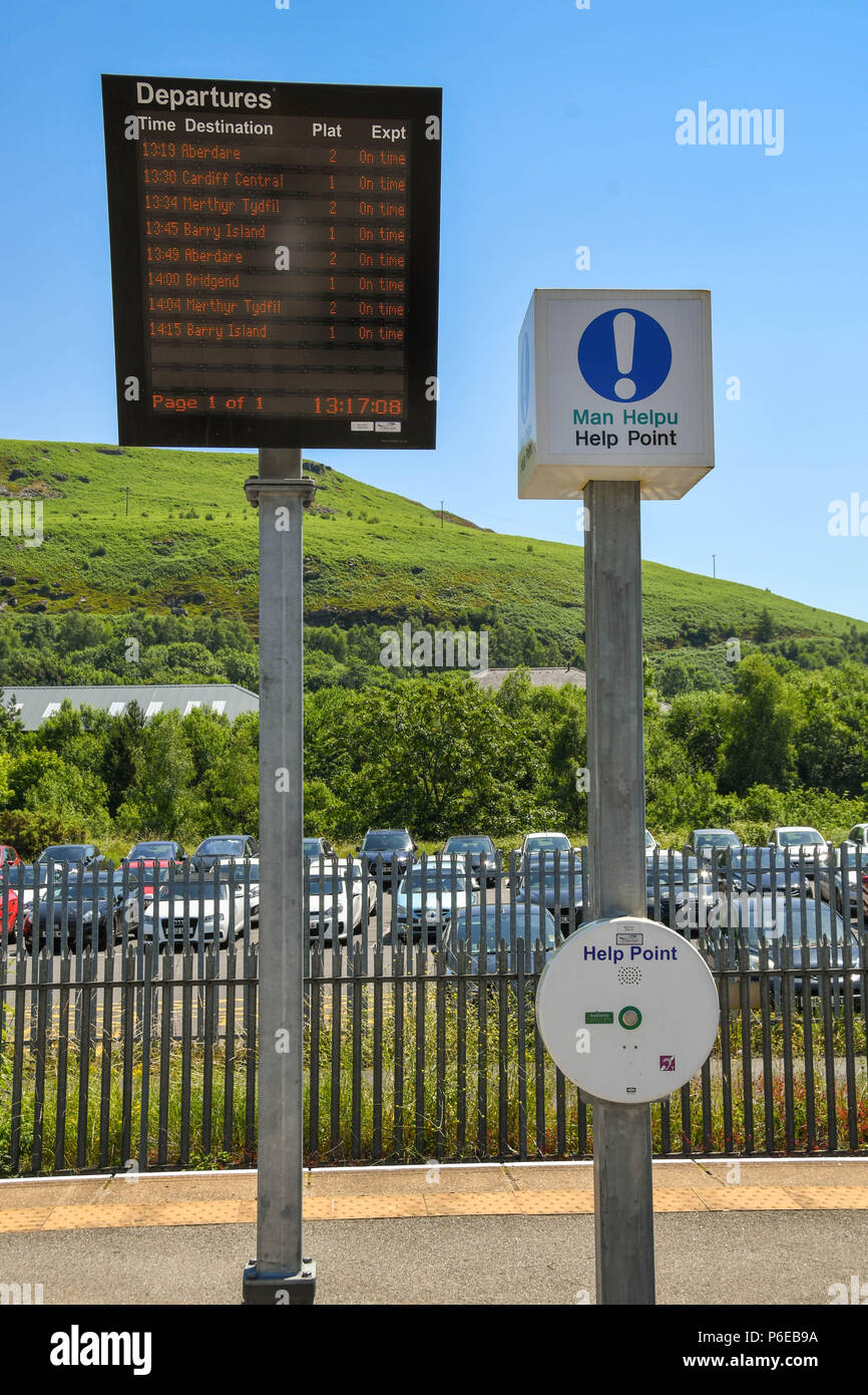 Electronic departures information board and an emergency Help Point on the platform at Abercynon railway station in south Wale Stock Photo