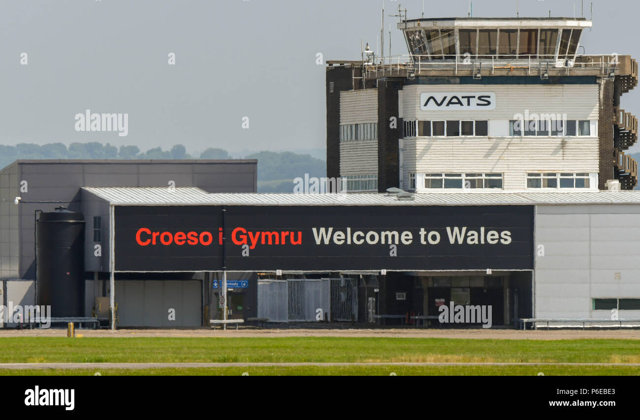 Landscape view of the terminal building and air traffic control tower at Cardiff Wales Airport with a bilingual 'Welcome to Wales' message Stock Photo