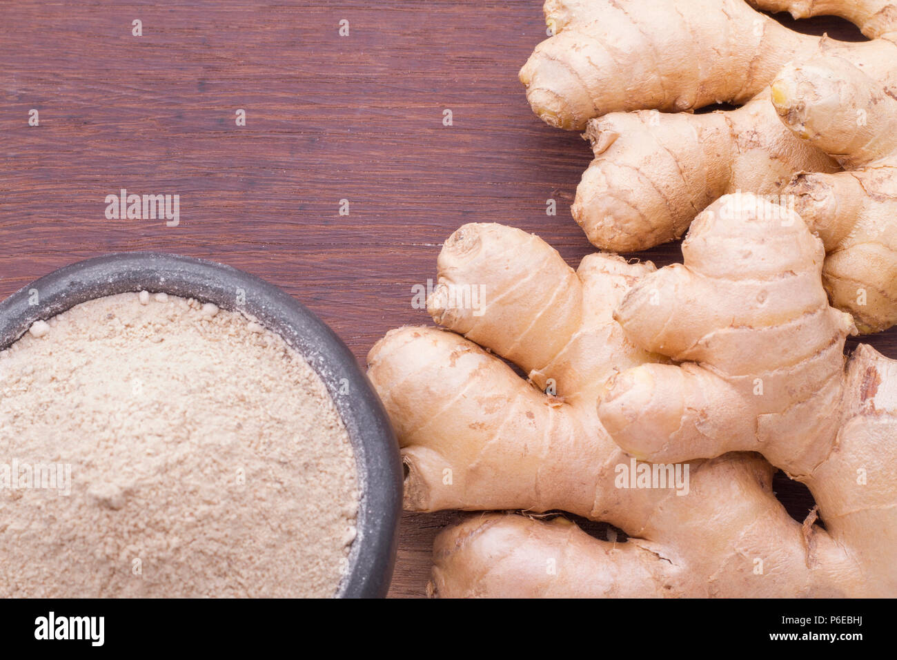 Roots and ginger powder on the table, top view Stock Photo