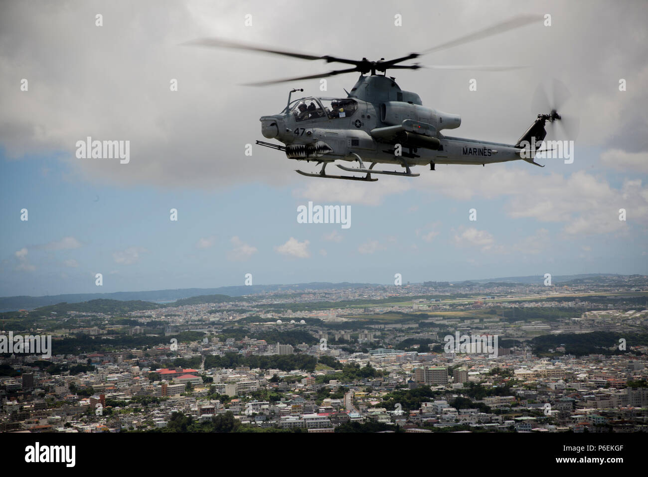 A U.S. Marine Corps AH-1Z Viper helicopter assigned to Marine Light Attack Helicopter Squadron 469, Marine Aircraft Group 39, 3rd Marine Aircraft Wing, under the unit deployment program with MAG-36, 1st MAW flies over Okinawa, Japan, after conducting a live fire event, June 27, 2018. Conducting live fire training is crucial to maintain efficiency and strength. (U.S. Marine Corps photo by Pfc. Ryan Persinger) Stock Photo