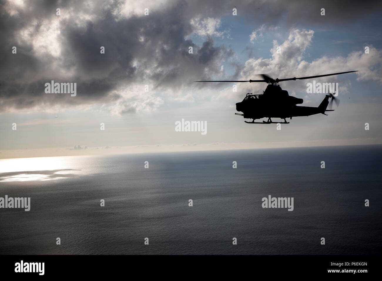 A U.S. Marine Corps AH-1Z Viper helicopter assigned to Marine Light Attack Helicopter Squadron 469, Marine Aircraft Group 39, 3rd Marine Aircraft Wing, under the unit deployment program with MAG-36, 1st MAW flies over Okinawa, Japan, after conducting a live fire event, June 27, 2018. Conducting live fire training is crucial to maintain efficiency and strength. (U.S. Marine Corps photo by Pfc. Ryan Persinger) Stock Photo