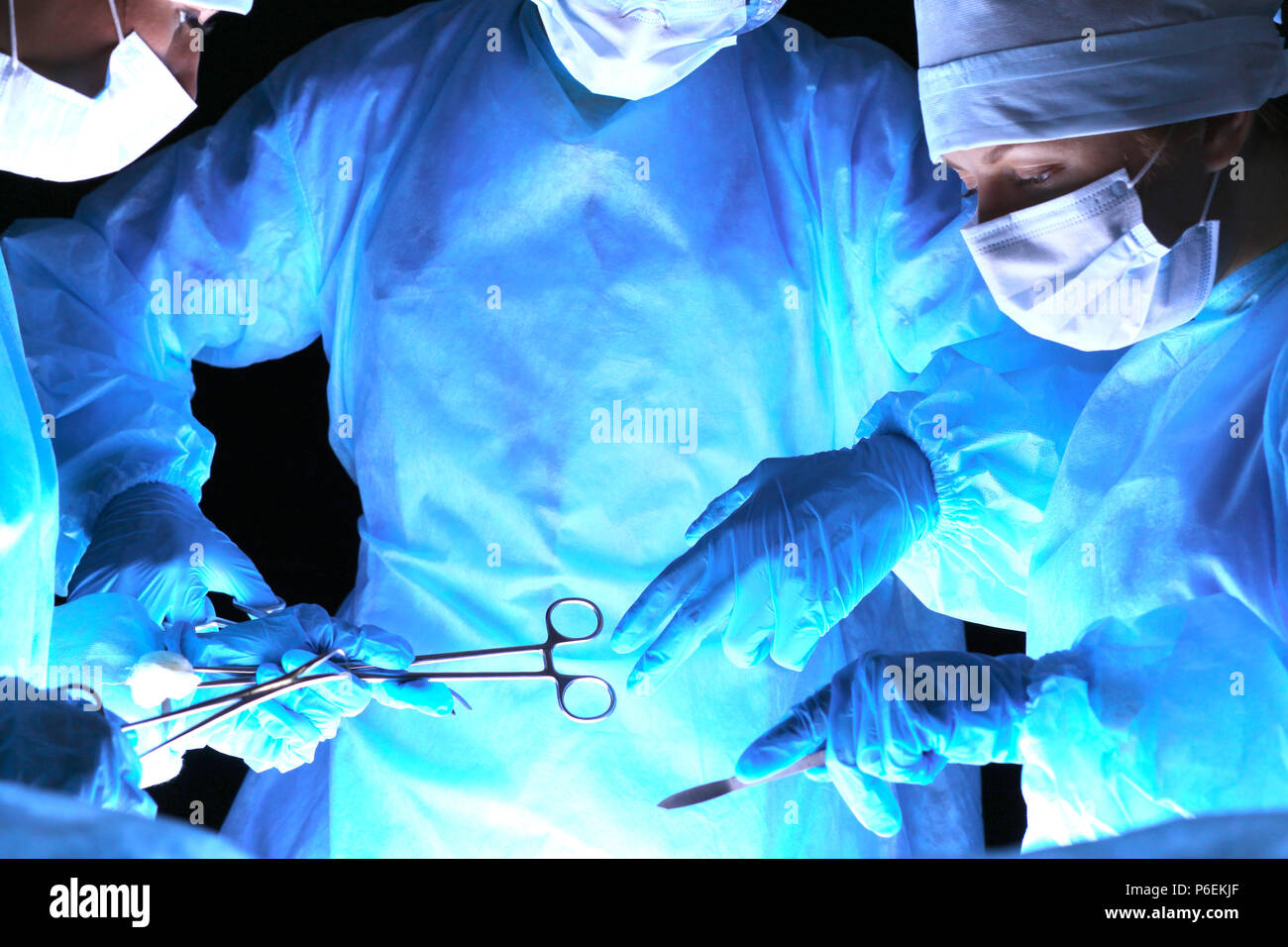 Group of surgeons in masks performing operation. Medicine, surgery and ...