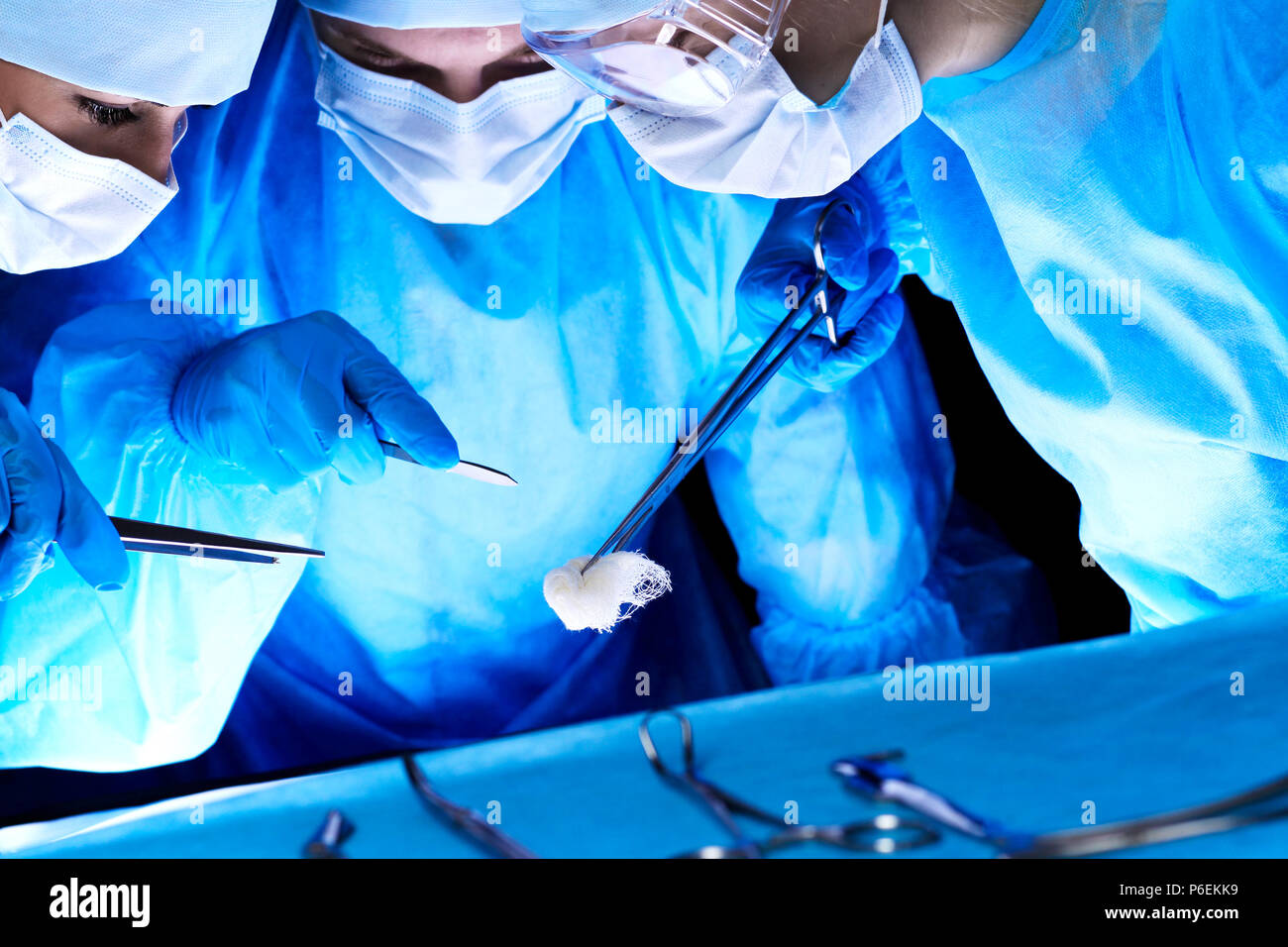 Group of surgeons in masks performing operation. Medicine, surgery and ...