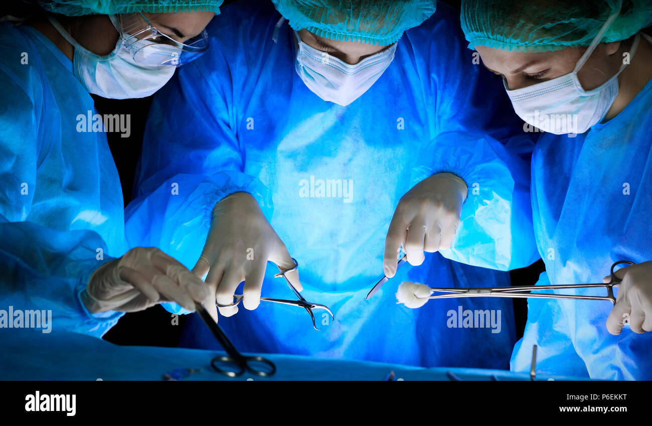 Group of surgeons in masks performing operation. Medicine, surgery and ...